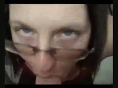 A gorgeous brunette wearing glasses is having amazing oral sex.